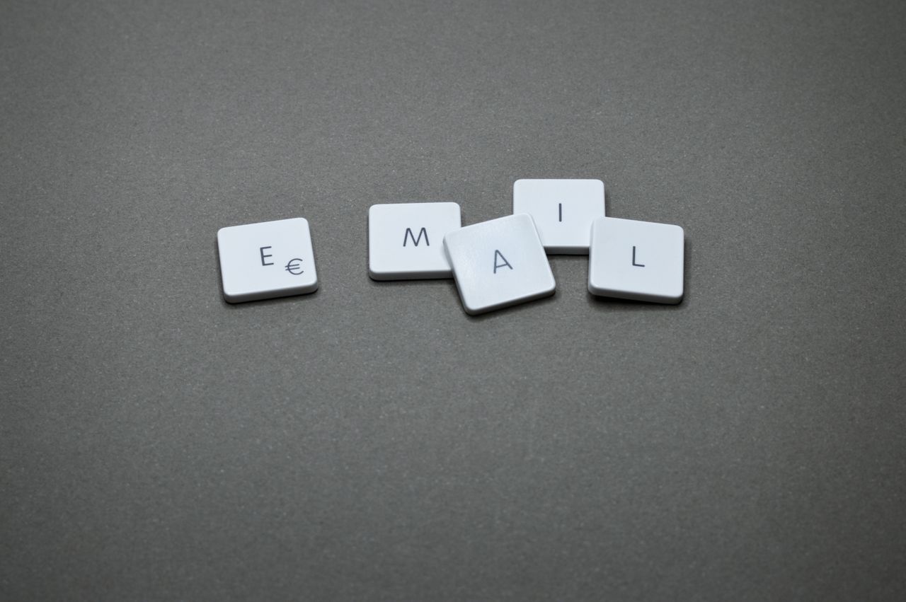 hero-img-02 Close-up of the word email formed with letter tiles on a gray surface.